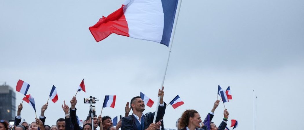 Les porte-drapeaux  Forent Manaudou et Mélina Robert-Michon, ainsi que d'autres athlètes français de la délégation française, naviguent sur la Seine lors de la cérémonie d'ouverture des Jeux Olympiques de Paris 2024. /Photo prise le 26 juillet 2024/FRANCK FIFE